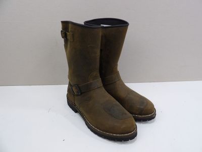 pair of brown leather boots with buckles on a white surface