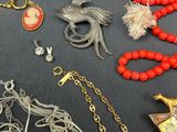 several different necklaces and bracelets are displayed on a table