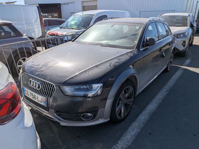 a black audi parked in a parking lot next to other cars