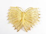 Broche papillon plaquée or jaune, aux ailes en filigrane