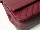 a close up of a red purse on a white surface