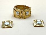 trois bijoux posés sur une surface blanche, sur fond blanc