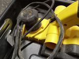 a tool in a case that has a cord and a tool in it