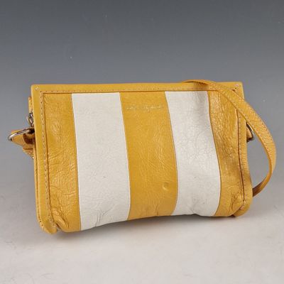 an image of a yellow and white striped purse on a table