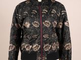 the bomber jacket is black and has a floral pattern on it