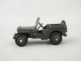 a toy army jeep with a steering wheel on a white surface