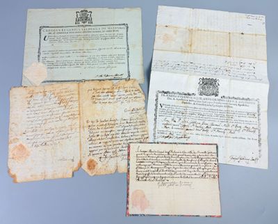 several old papers are sitting on top of a table
