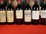 several bottles of wine are lined up on a table