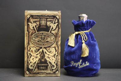 an image of a bottle of perfume sitting next to a box