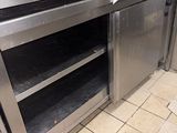 a stainless steel kitchen with two ovens in it