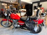 a red motorcycle that is parked in a garage