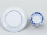 a white plate and a blue and white cup on a table