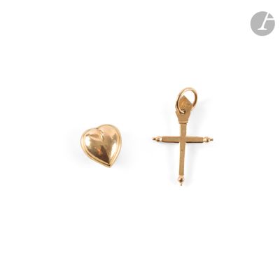 a close up of a cross and a heart on a white background