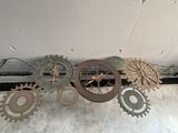 a bunch of gears hanging from the ceiling of a building