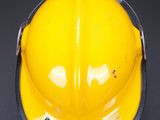 a yellow hard hat on a black background