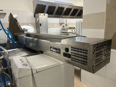an image of a commercial kitchen with a washer and dryer