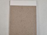 a close up of a piece of cardboard on a white surface