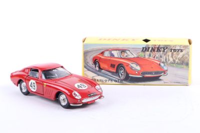 a small red toy car in front of a box