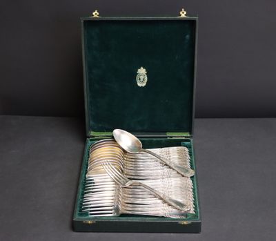 a set of silverware in a case with a spoon and spoon rest