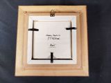 an image of a picture frame with a note attached to it