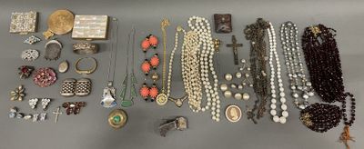 many different types of necklaces and bracelets laid out on a table