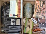 a box full of assorted items including a camera and a book