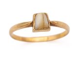a close up of a gold ring with a white stone on it