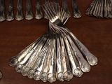 a lot of silver spoons and forks on a table
