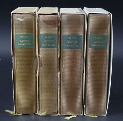 three old books sitting on top of each other on a table