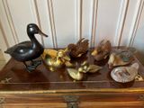 a wooden chest with a bunch of birds on top of it