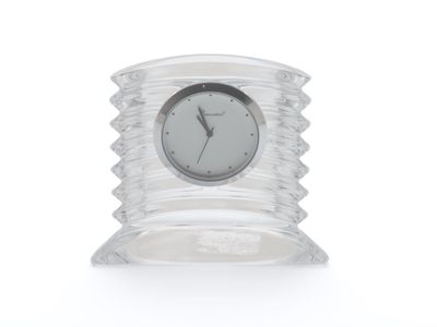 une horloge transparente posée sur une table transparente