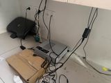 a laptop on the floor with wires all around it