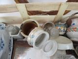 a pile of dishes and cups sitting on a table