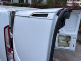 a white van with its door open on the side of the road