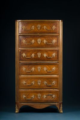 an antique chest of drawers with a wooden top and brass handles