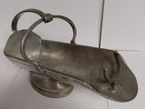 a metal object that is on a white surface
