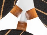 a close up of a chair with a black and gold striped seat