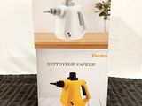 packaging of a yellow and white kettle sitting on top of a wooden table