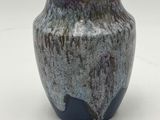 a vase that is sitting on a white surface