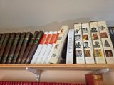 many books that are on a shelf in the room
