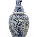 a large blue and white vase with a bird on it