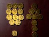 some gold coins and a cross on a red surface
