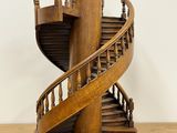 a wooden sculpture of a spiral staircase on a table