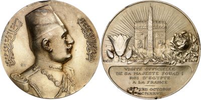 an image of a silver medal with a picture of a man in a turban