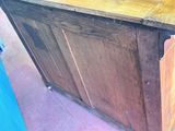 a wooden cabinet with a wooden top on the floor