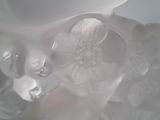 a close up of a glass vase with a flower inside of it