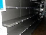 many empty shelves in a store that are empty
