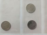 three different types of coins are shown in a clear case