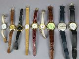 several different types of watches are lined up on a table