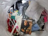 a plastic bag full of clothes and a book